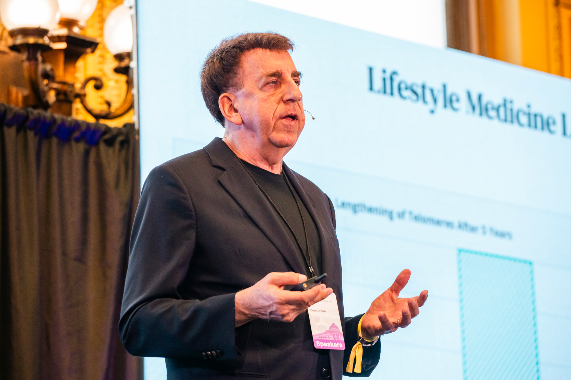 A speaker presenting lifestyle medicine research on stage at the HOPE healthspan summit.