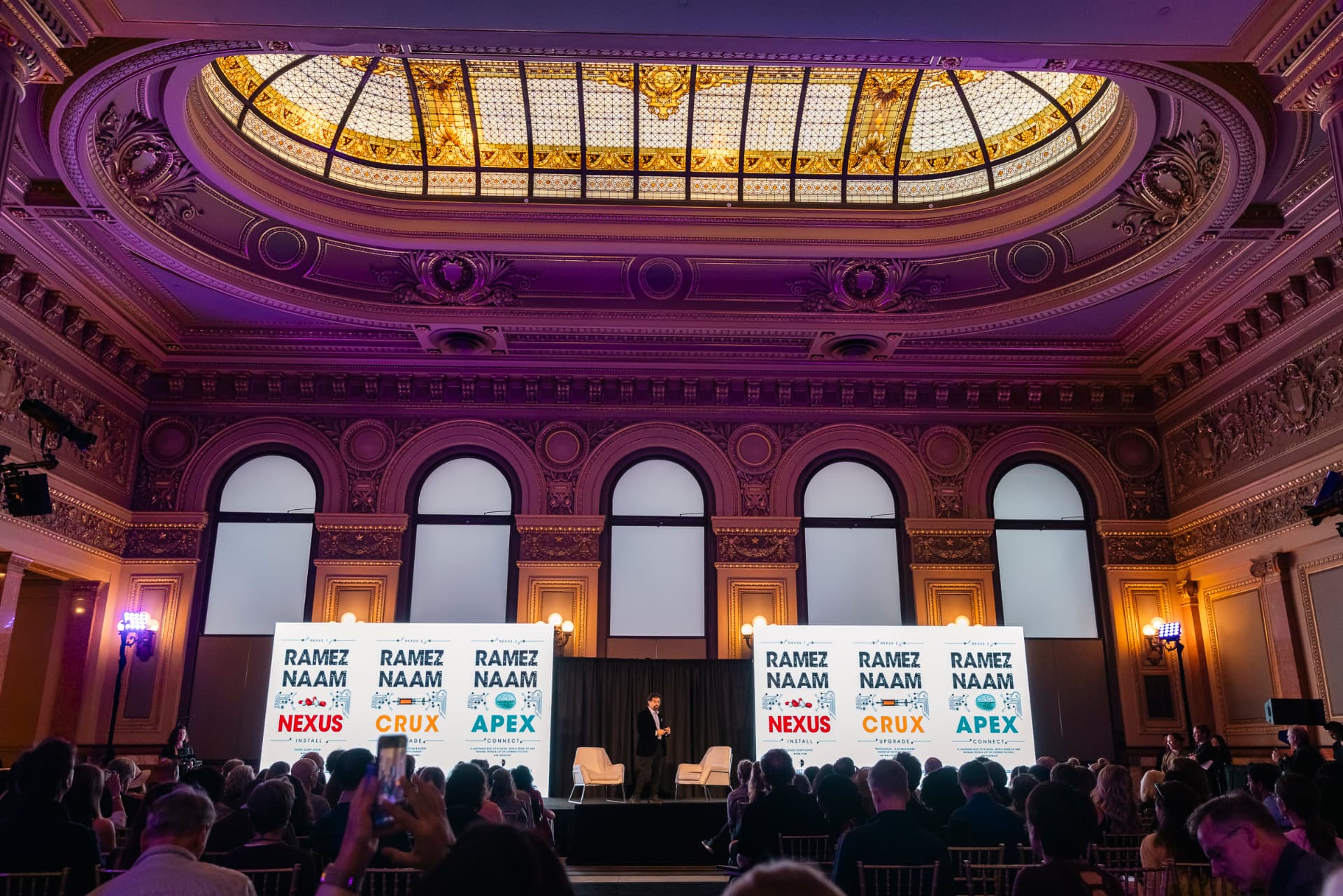 The IMAGINE Grand Opening in a domed San Francisco ballroom, a speaker on stage before a full audience.