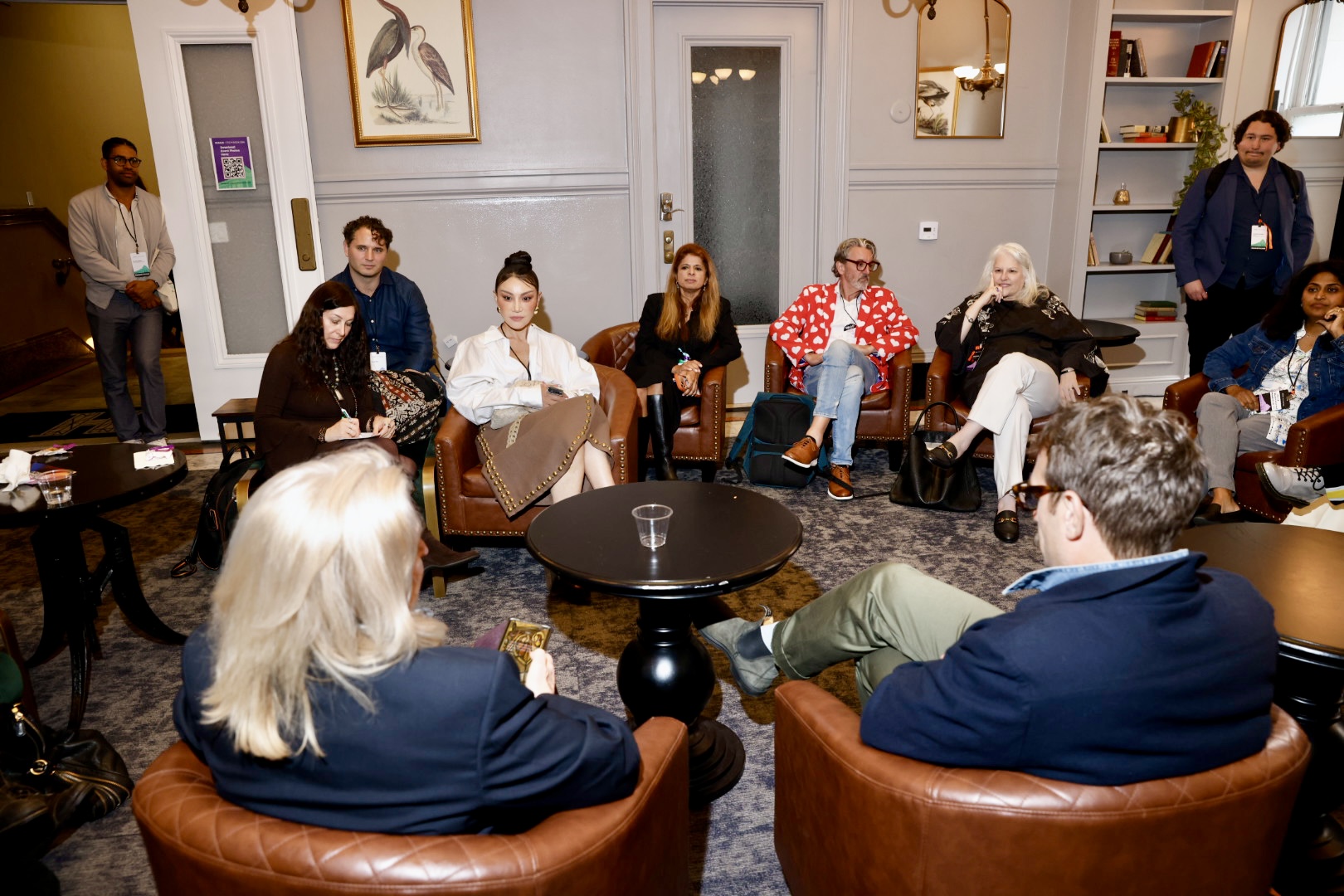 A small group mid-conversation in a lounge at Human+Tech Week